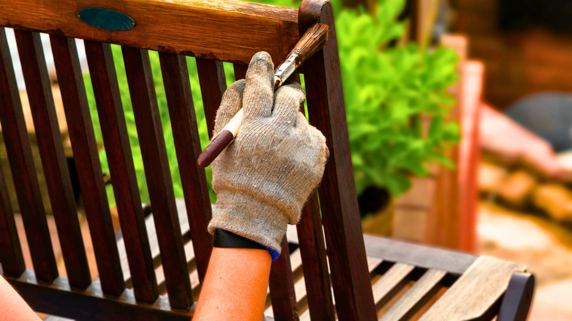 Painting and applying protective varnish on a wooden garden chair